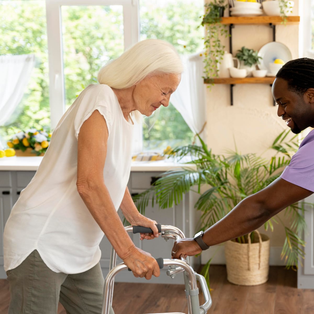 Care giver helping an older woman with her walker